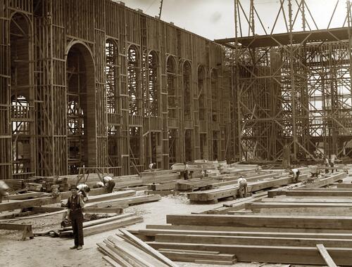 Construction workers framing posts and trusses for the Palace of Varied Industries at the 1904 World's Fair